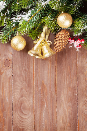 Christmas tree branch with decor on wooden background with copy spaceの写真素材