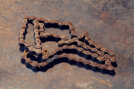 Old rust chain on metal work bench
