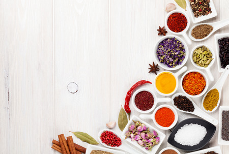 Various spices on white wooden background. Top view with copy spaceの写真素材