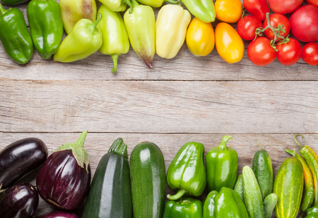 Fresh farmers garden vegetables on wooden table. Top view with copy spaceの写真素材