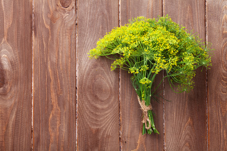 Fresh garden dill on wooden table. Top view with copy spaceの写真素材