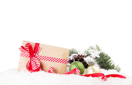 Christmas gift box and decor in snow. Isolated on white backgroundの写真素材