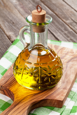 Olive oil bottle on cutting boardの写真素材