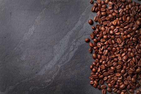 Coffee beans on stone table. Top view with copy spaceの写真素材