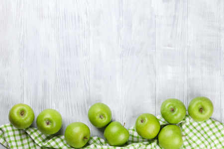 Green apples over wooden table. Top view with copy spaceの写真素材