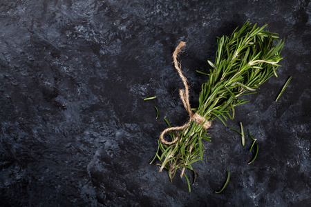 Rosemary herb bunch over stone background. Top view with copy spaceの写真素材