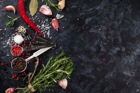 Herbs and spices over black stone background. Top view with copy spaceの写真素材