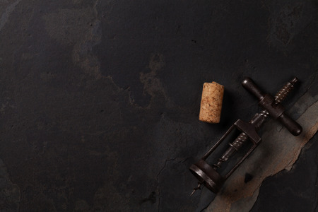 Vintage corkscrew on stone table. Top view with copy space