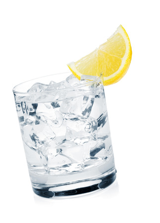 Glass of pure water with ice cubes and lemon slice. Isolated on white backgroundの写真素材