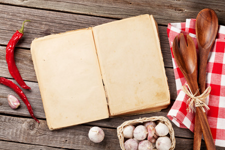 Blank vintage recipe cooking book, utensils and ingredients on wooden table. Top view with copy spaceの写真素材
