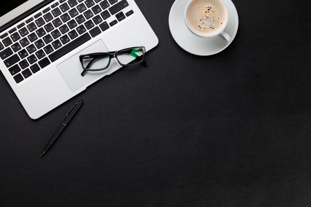 Office leather desk table with laptop and coffee cup. Top view with copy space