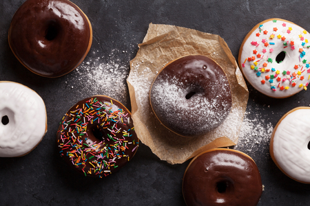 Colorful donuts on stone table. Top viewの写真素材