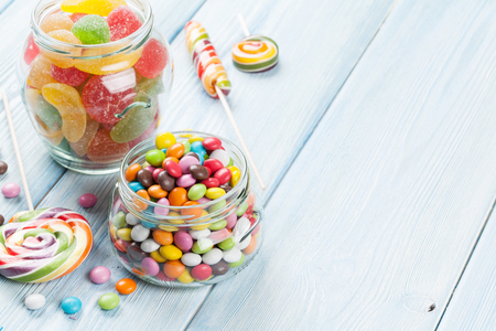 Colorful candies on wooden table background. View with copy spaceの写真素材