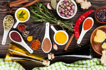 Herbs and spices over wood background. Top viewの写真素材