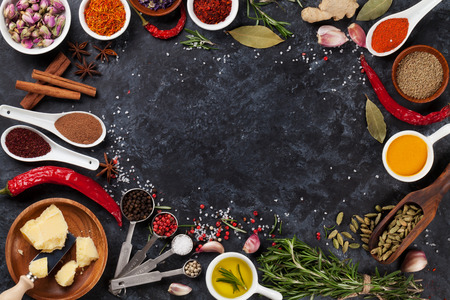 Herbs, condiments and spices on stone background. Top view with copy spaceの写真素材