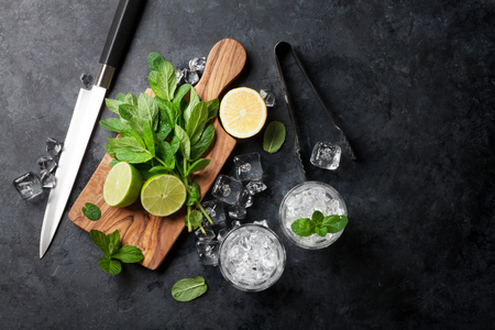 Mojito cocktail making. Mint, lime, ice ingredients and bar utensils. Top viewの写真素材