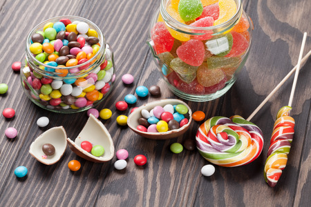 Colorful candies on wooden table backgroundの写真素材
