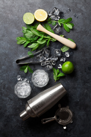 Mojito cocktail making. Mint, lime, ice ingredients and bar utensils. Top viewの写真素材