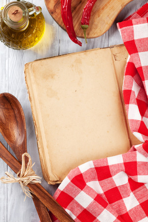 Kitchen table with cookbook, utensils and ingredients. Top view with copy spaceの写真素材