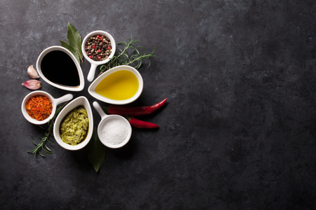 Herbs, condiments and spices on stone background. Top view with copy spaceの写真素材