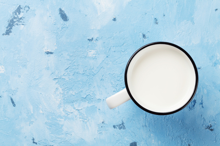 Milk cup on stone table. Dairy products. Top view with copy spaceの写真素材