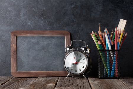 Alarm clock, supplies and chalk board for your text. Back to school concept with copy spaceの写真素材