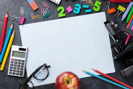 School and office supplies in front of chalk board. Back to school concept with copy spaceの写真素材