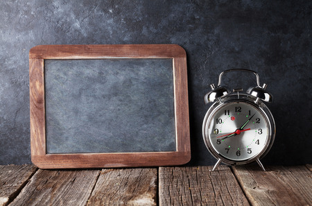 Alarm clock and chalk boad for your text. Back to school concept with copy spaceの写真素材