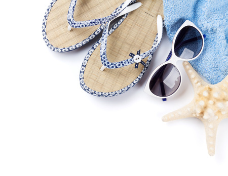Beach accessories. Flip flops, sunglasses and starfish. Isolated on white background. Top view with copy spaceの写真素材