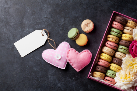 Colorful macaroons and greeting tag. Top view with copy space for textの写真素材
