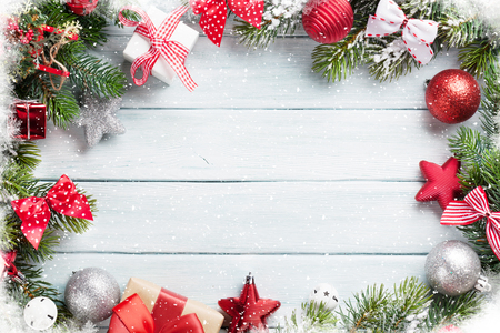 Christmas wooden background with snow fir tree and decoration. Top view with copy space for your textの写真素材