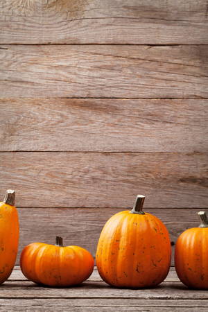 Autumn pumpkins on wooden board table. View with copy spaceの写真素材