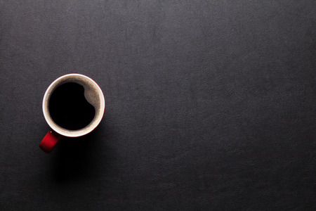 Office leather desk table with coffee cup. Top view with copy spaceの写真素材