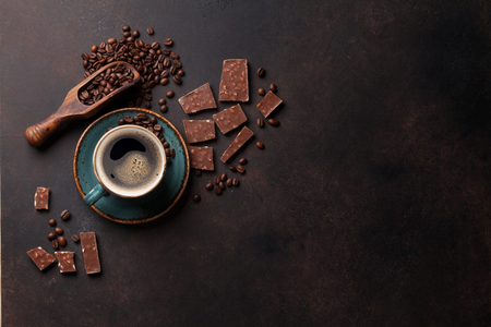 Coffee cup, beans and chocolate on old kitchen table. Top view with copyspace for your textの写真素材