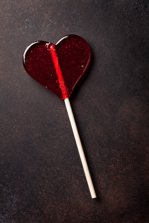 Valentines day greeting card. Sweet candy heart on stone table. Top viewの写真素材