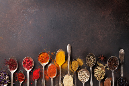 Various spices spoons on stone table. Top view with space for your textの写真素材