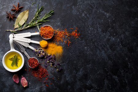 Herbs and spices over black stone background. Top view with copy spaceの写真素材
