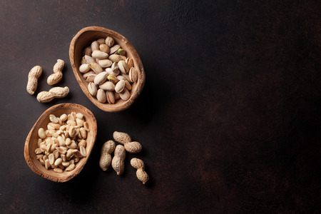 Various nuts on stone table. Top view with copy space
