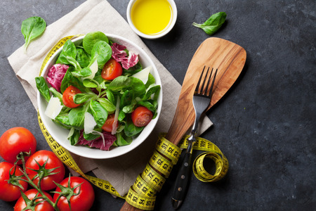 Healthy salad bowl on stone table. Top view with copy spaceの写真素材