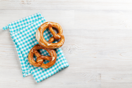 Pretzel. Beer snacks on wooden table. Top view with copy spaceの写真素材