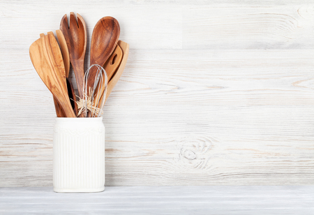 Kitchen utensils in front of wooden wall with space for your textの写真素材