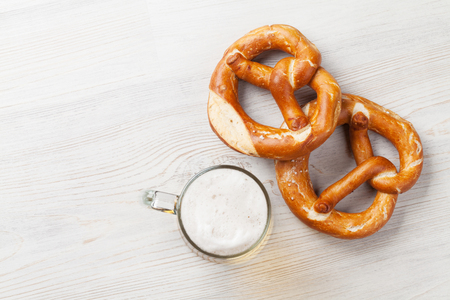Lager beer and pretzel on wooden table. Top view with copy spaceの写真素材