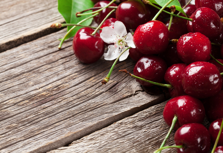 Fresh garden cherry on wooden table. With copy spaceの写真素材