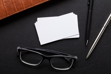 Office desk with supplies. Blank business cards. Top view with space for your textの写真素材