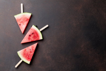 Fresh watermelon slices on stone background. Top view with space for your textの写真素材