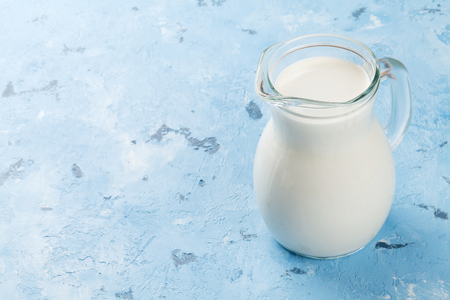 Milk jug on stone table. Dairy products. View with copy spaceの写真素材