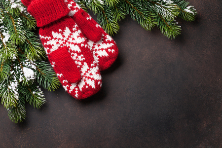 Christmas stone background with fir tree and mittens. Top view with copy spaceの写真素材