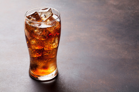 Cola glass with ice cubes with copy space