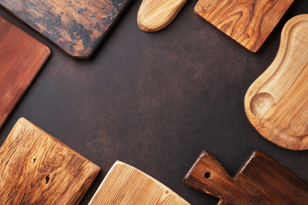 Various cutting boards on stone table. Cooking utensils. Top view with space for your textの写真素材
