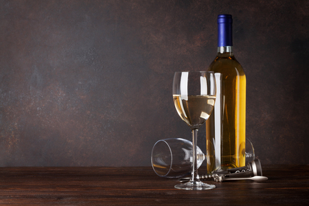 White wine bottle and glass in front of blackboard wall. With copy space for your textの写真素材
